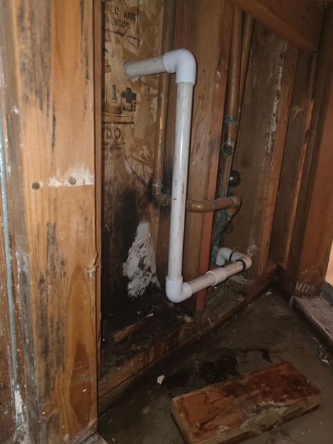 New PVC AC condensation line installed inside the wall cavity of a Chino Hills home