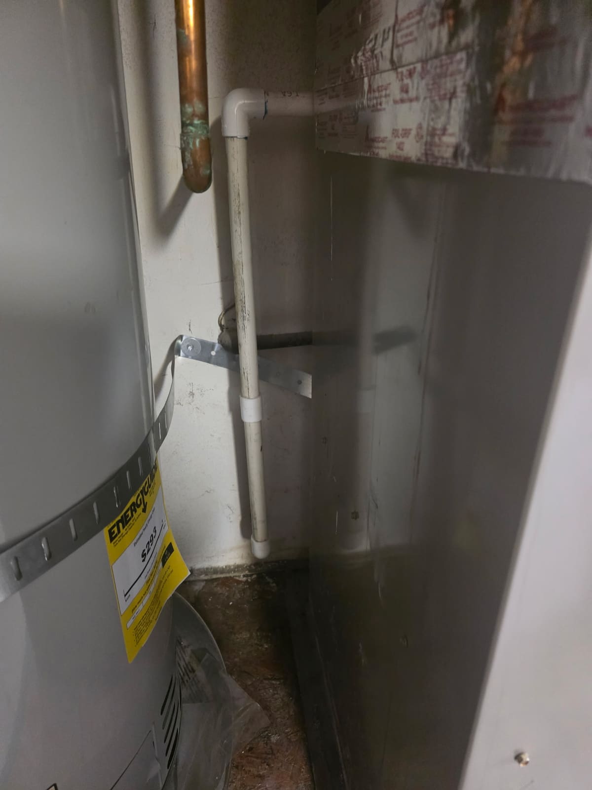 New condensate drain line strapped to the wall beside the water heater in Chino Hills