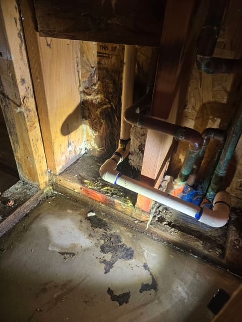 Water damaged wall framing and staining around a leaking AC condensation line in a Chino Hills home
