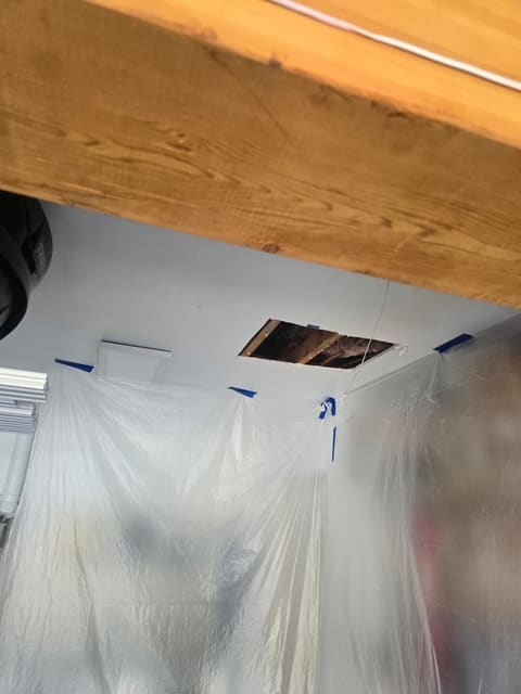 Wide view showing how small the ceiling access cut is compared to the whole garage ceiling