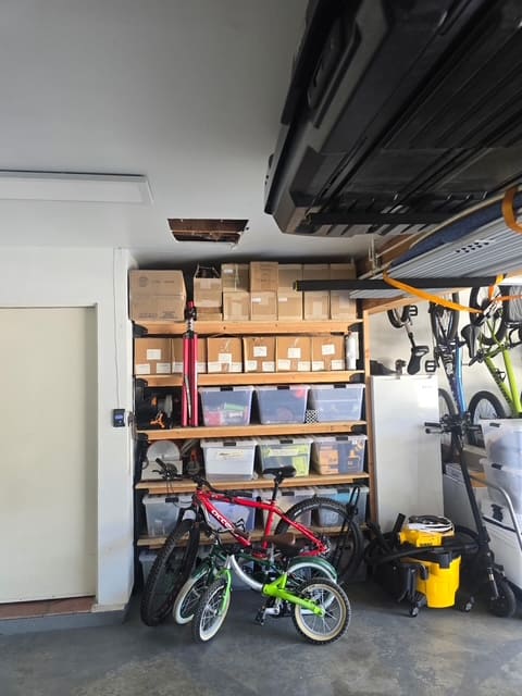 Garage shelving and bikes returned to place after leak detection cleanup