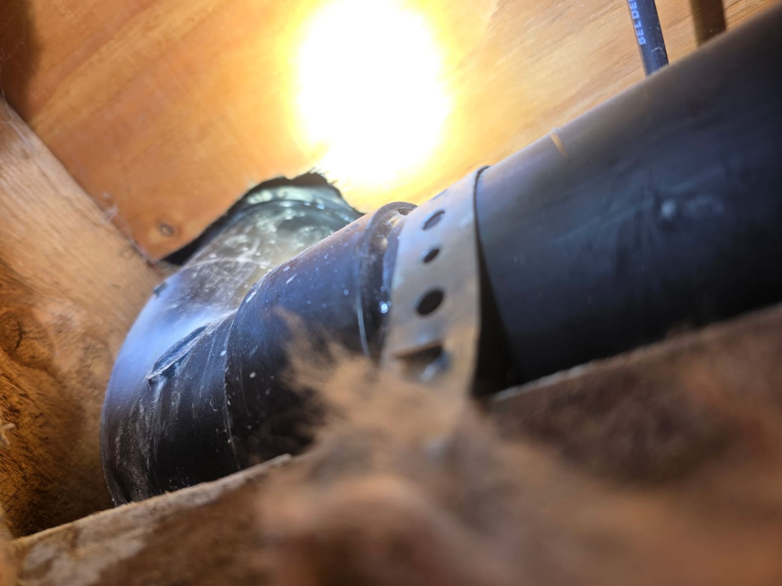 Failed ABS drain elbow at a metal hanger strap found during Pacific Palisades leak detection