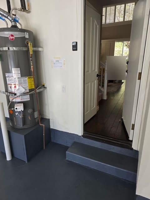 Garage water heater beside the door into an Aliso Viejo home during leak detection
