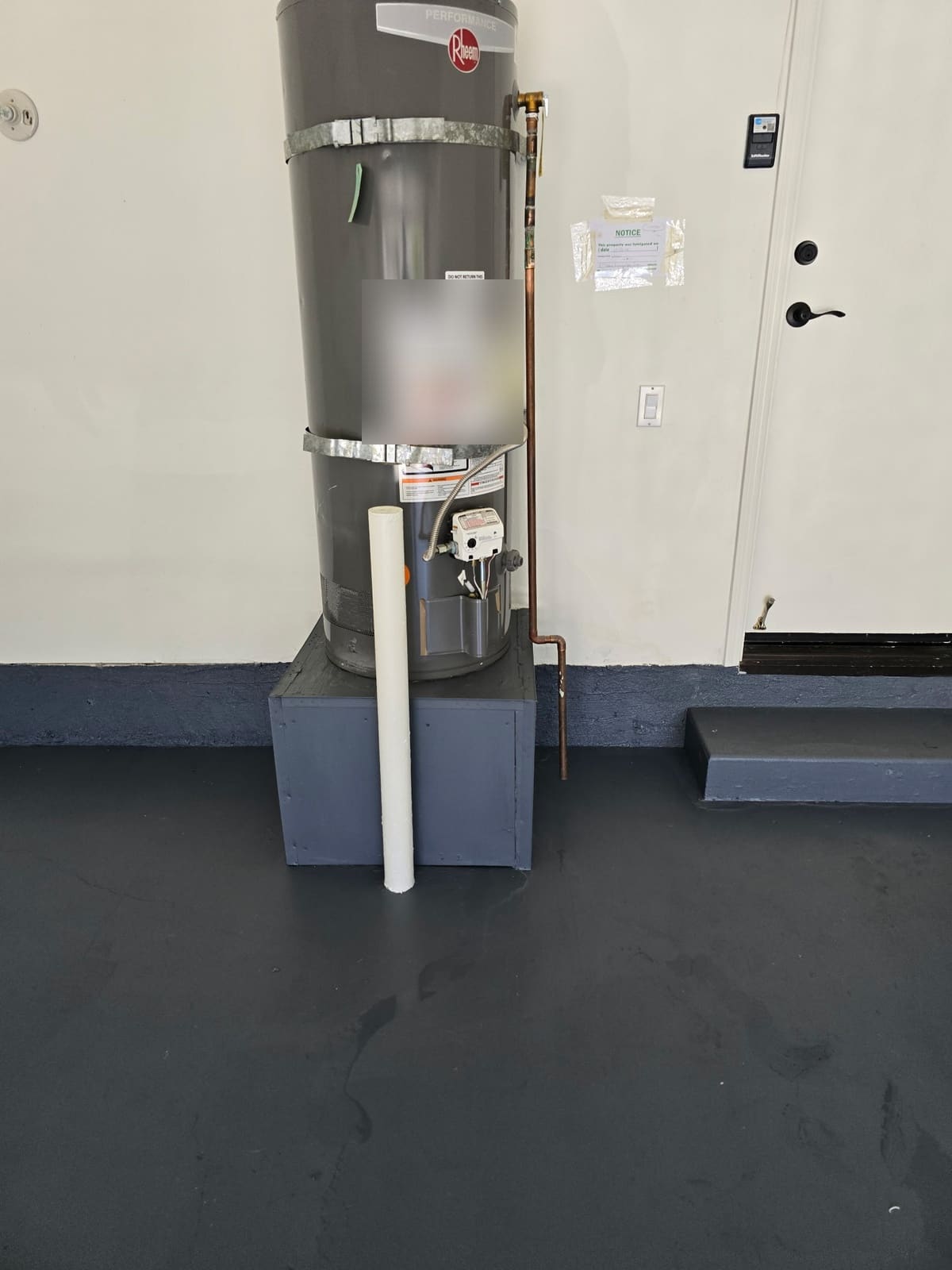 Wet trail across the garage floor near the water heater before leak detection
