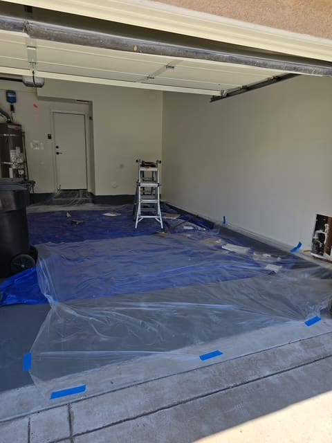 Garage floor fully covered in protective sheeting before reroute work began